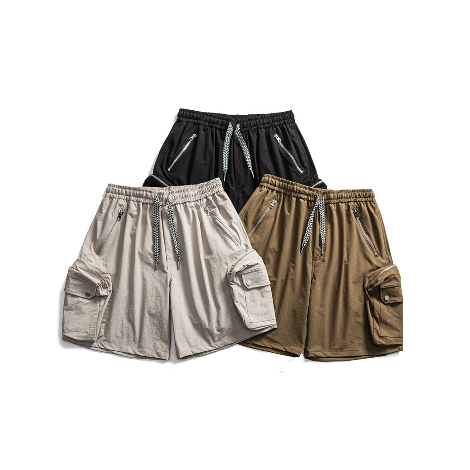 Front view of cargo shorts in black, light beige, and brown, with elastic waists, drawstrings, zip pockets, and side cargo