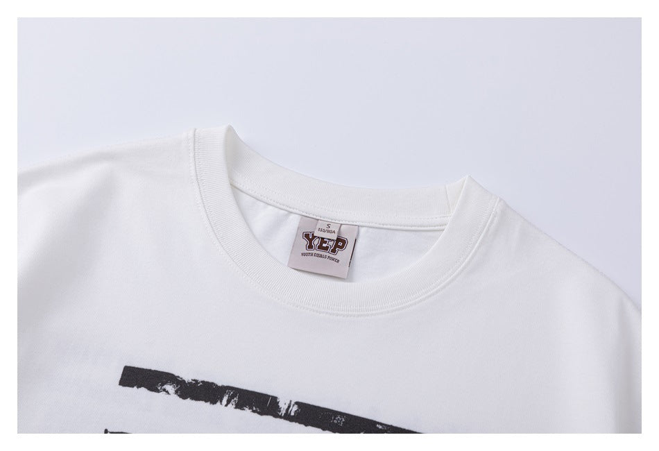 Close-up of the white T-shirt's ribbed crew neckline, sewn-in label, and upper portion of its black chest graphic.