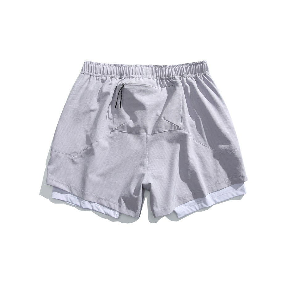 Pale lavender layered athletic shorts, back view, with an elastic waistband, center rear pocket and white inner shorts.