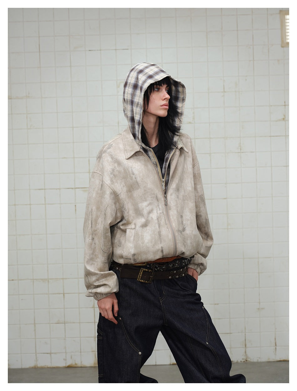 Model in a beige mottled zip-up jacket with a plaid hood, shown at an angled front view.
