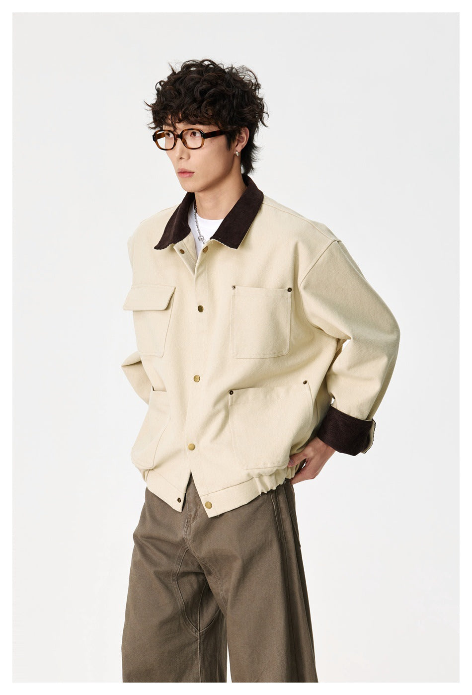 Model wearing a cream utility jacket with a dark brown collar and cuffs, snap closure and multiple pockets.
