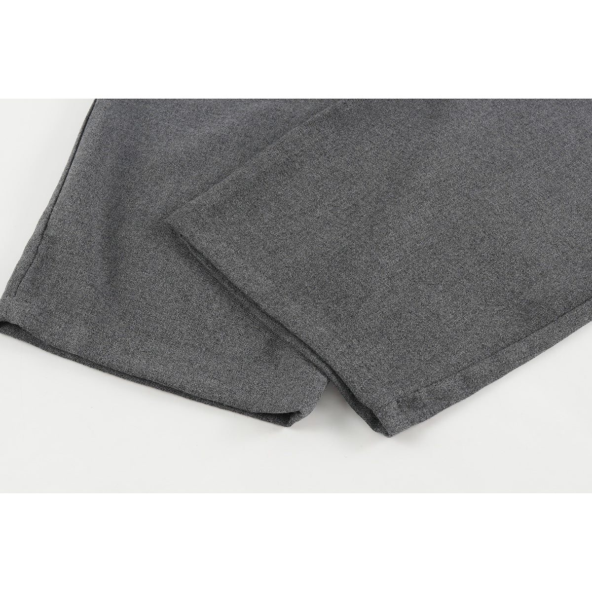 Close-up of charcoal gray pants showing the wide leg and stitched hem.