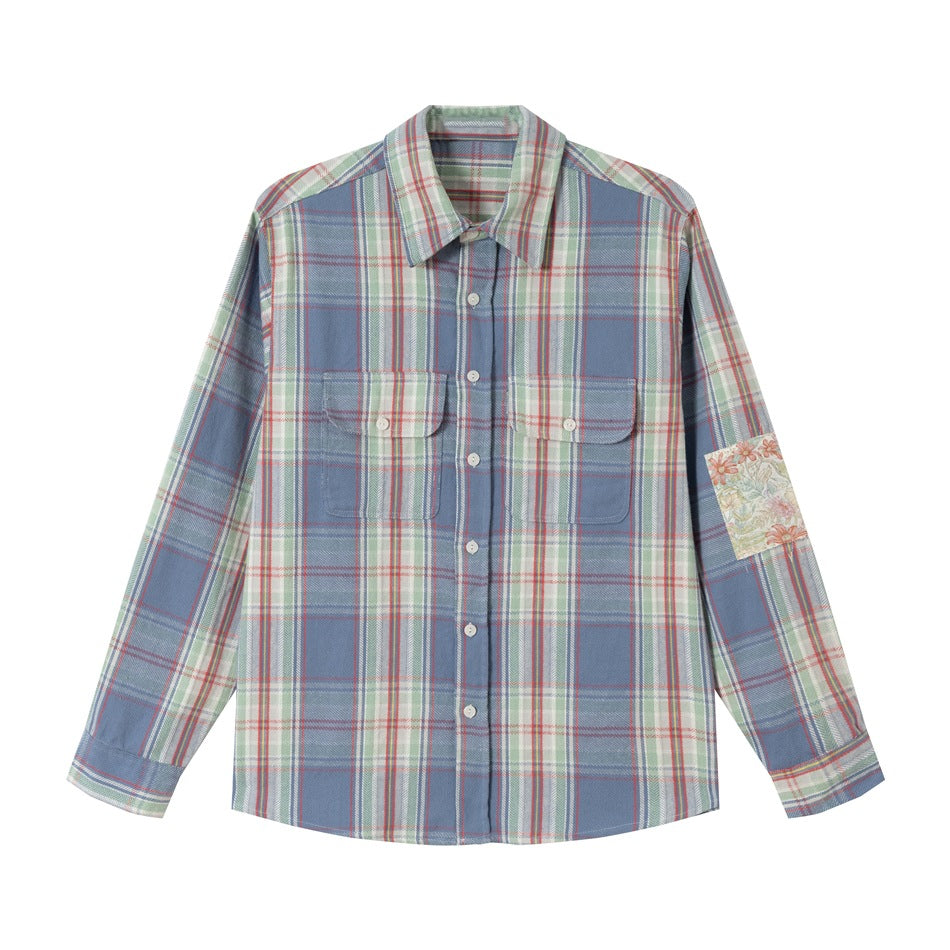 Blue, green, red and cream plaid long-sleeve shirt with two flap chest pockets and floral sleeve patch, flat lay