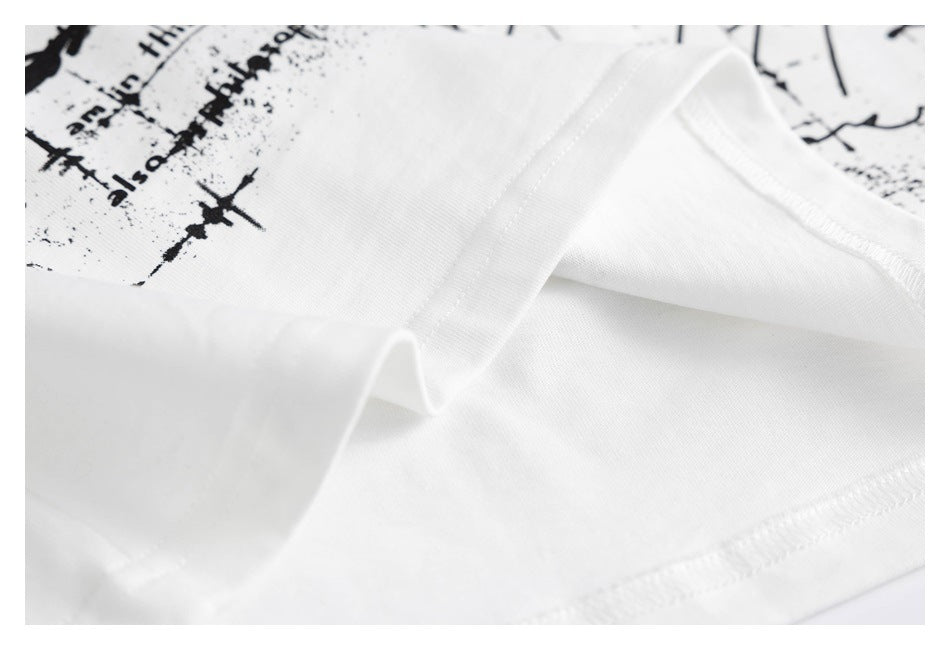 Close-up of a white shirt's folded neckline and stitching, with part of its black text print visible.