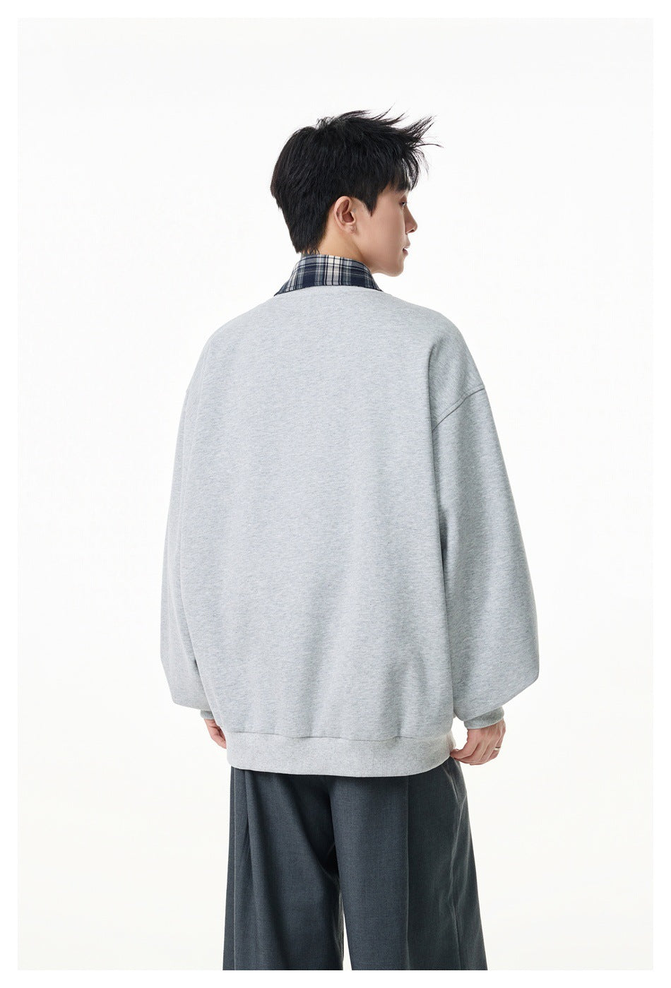 Model wearing a light gray jacket, shown from the back with a checked collar visible.