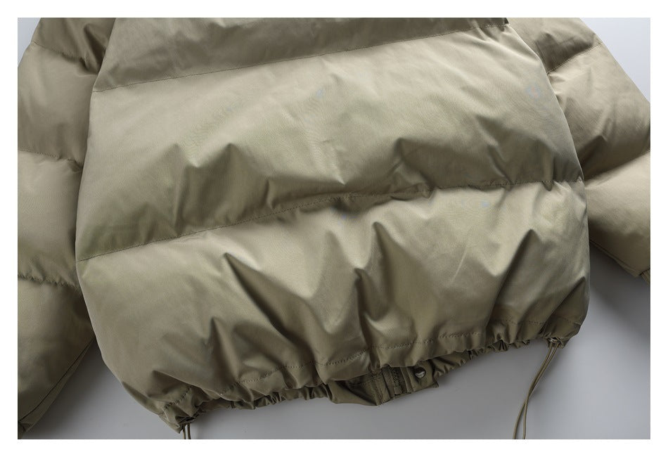 Close-up of the jacket's lower back hem with gathered elastic and adjustable drawcords.