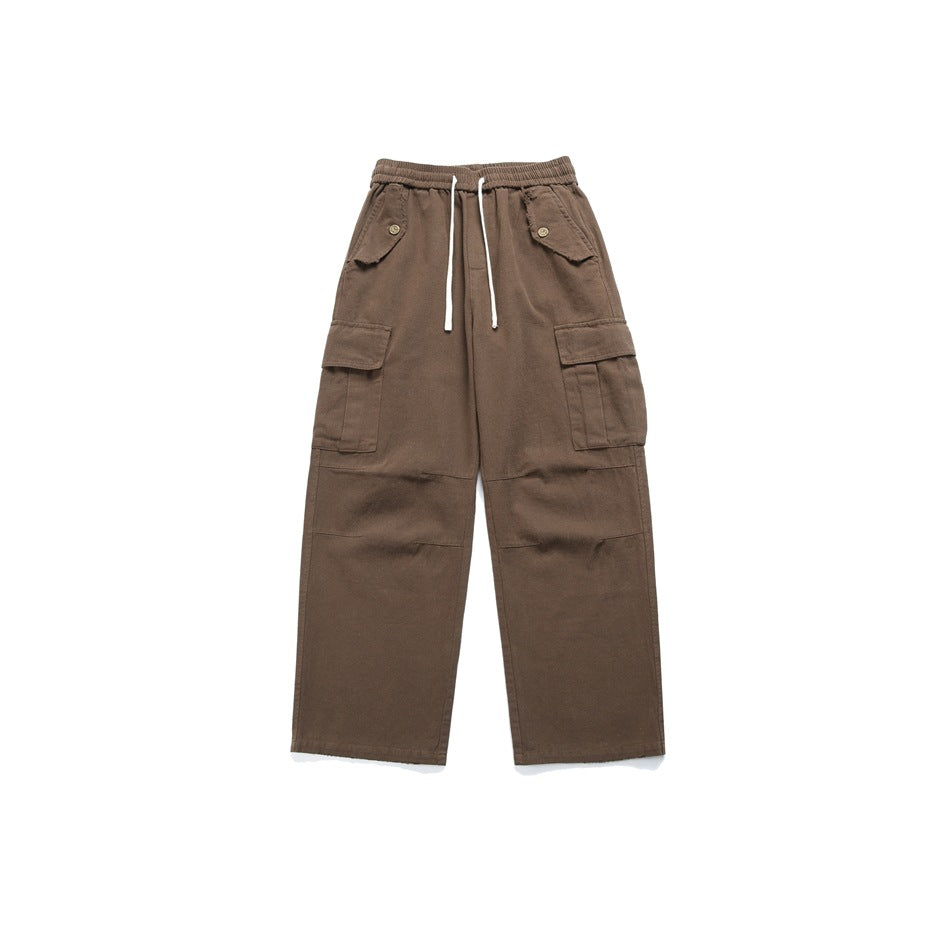 Brown cargo pants flat lay with drawstring elastic waist, flap pockets and wide straight legs