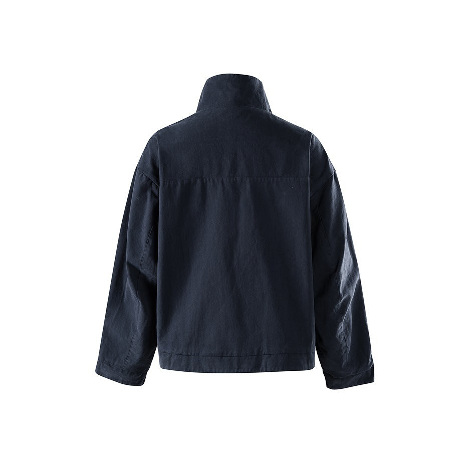 Navy jacket back view showing stand collar, back yoke seam, dropped shoulders and long sleeves on white background
