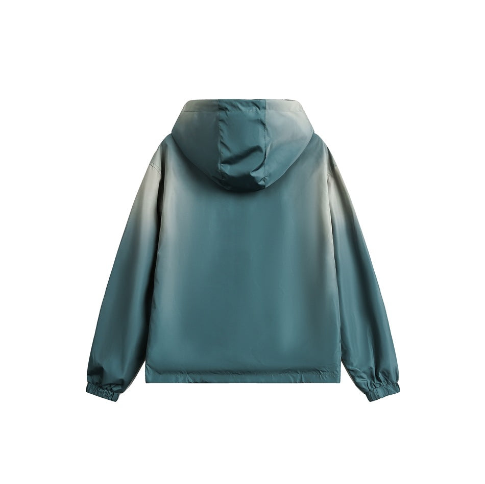 Back view of a teal hooded jacket with long sleeves and elastic cuffs, shown flat against a white background.
