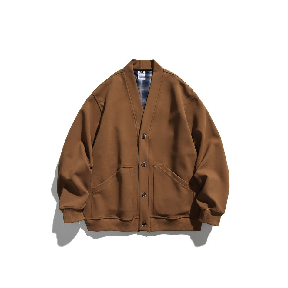 Brown V-neck button-front cardigan jacket with large front pockets and ribbed hem, flat lay with plaid neck lining