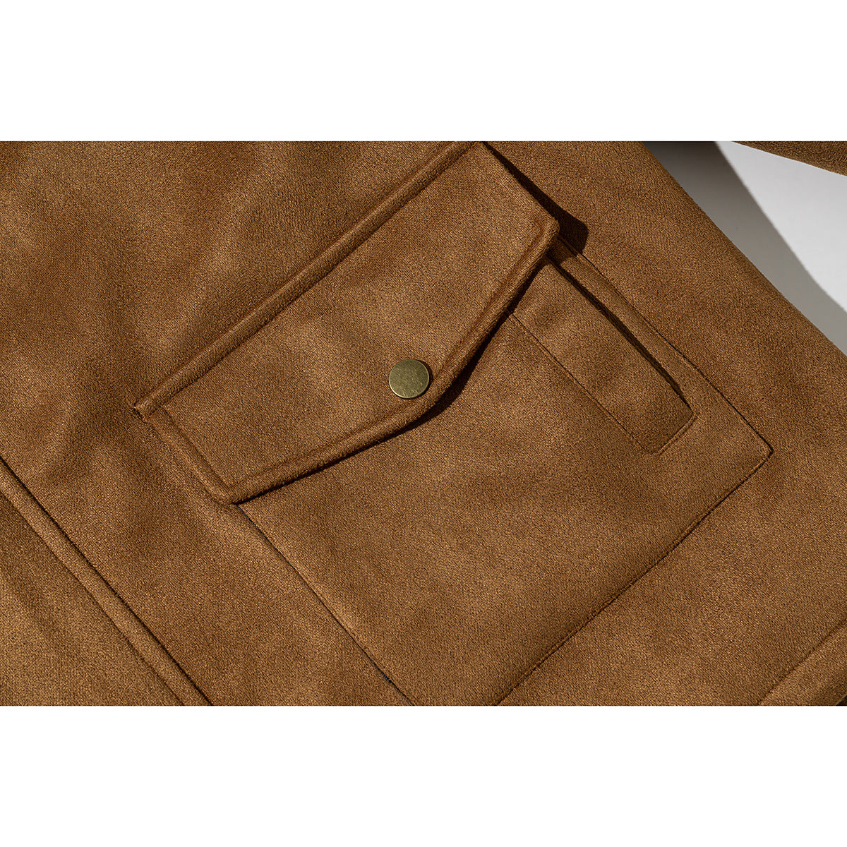 Close-up of a brown jacket's flap pocket with a round metal snap and visible stitching.