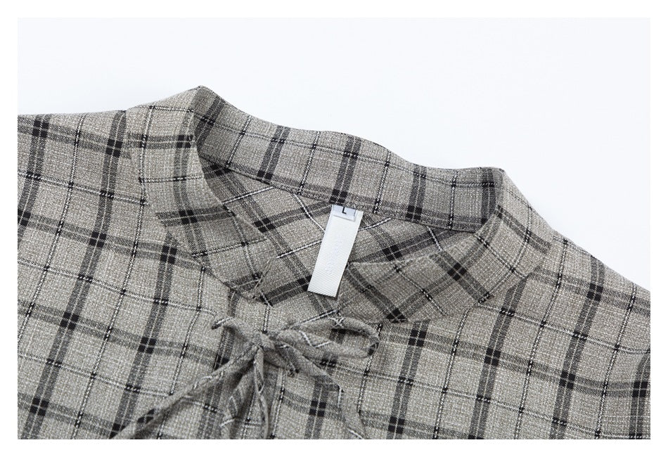 Close-up of the blouse's plaid stand collar, tie closures, and small size tag marked L.