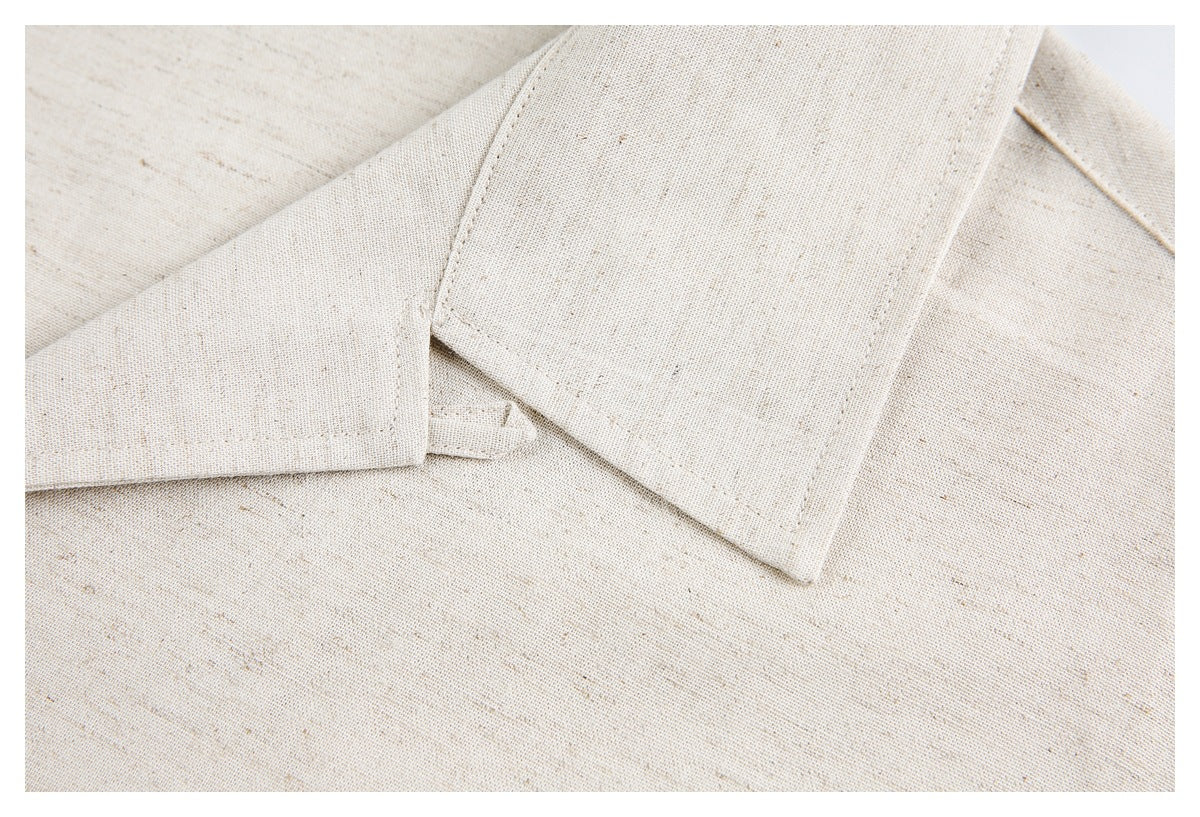 Close-up of the cream shirt's wide collar and stitched collar edge.