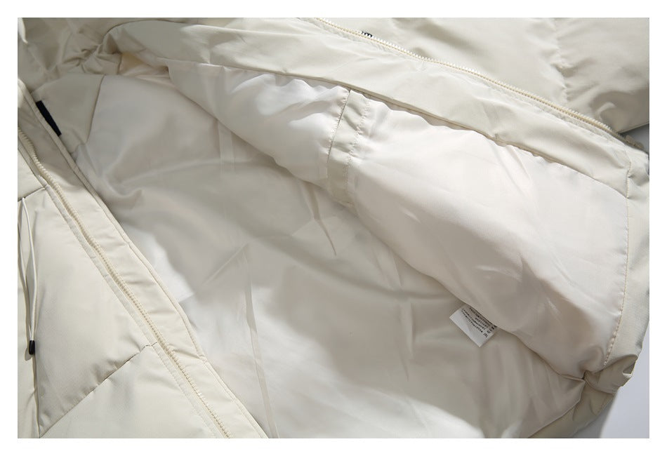 Inside view of the ivory jacket showing its lining, zipper, and a small care label.