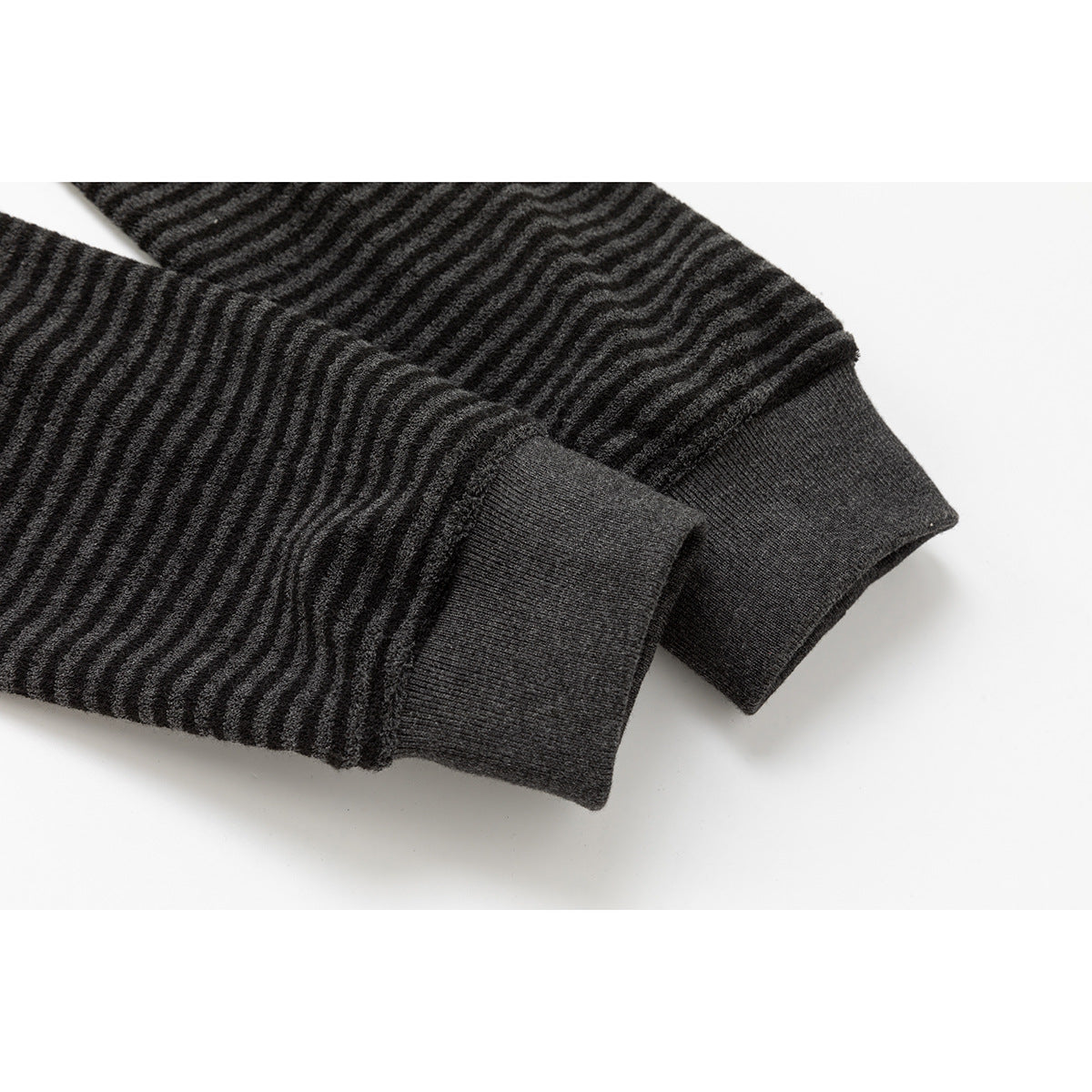 Close-up of the charcoal striped jacket sleeves and plain dark ribbed cuffs.
