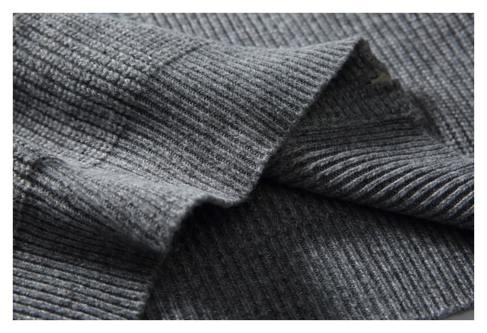 Close-up of folded rib-knit sections of a gray sweater.