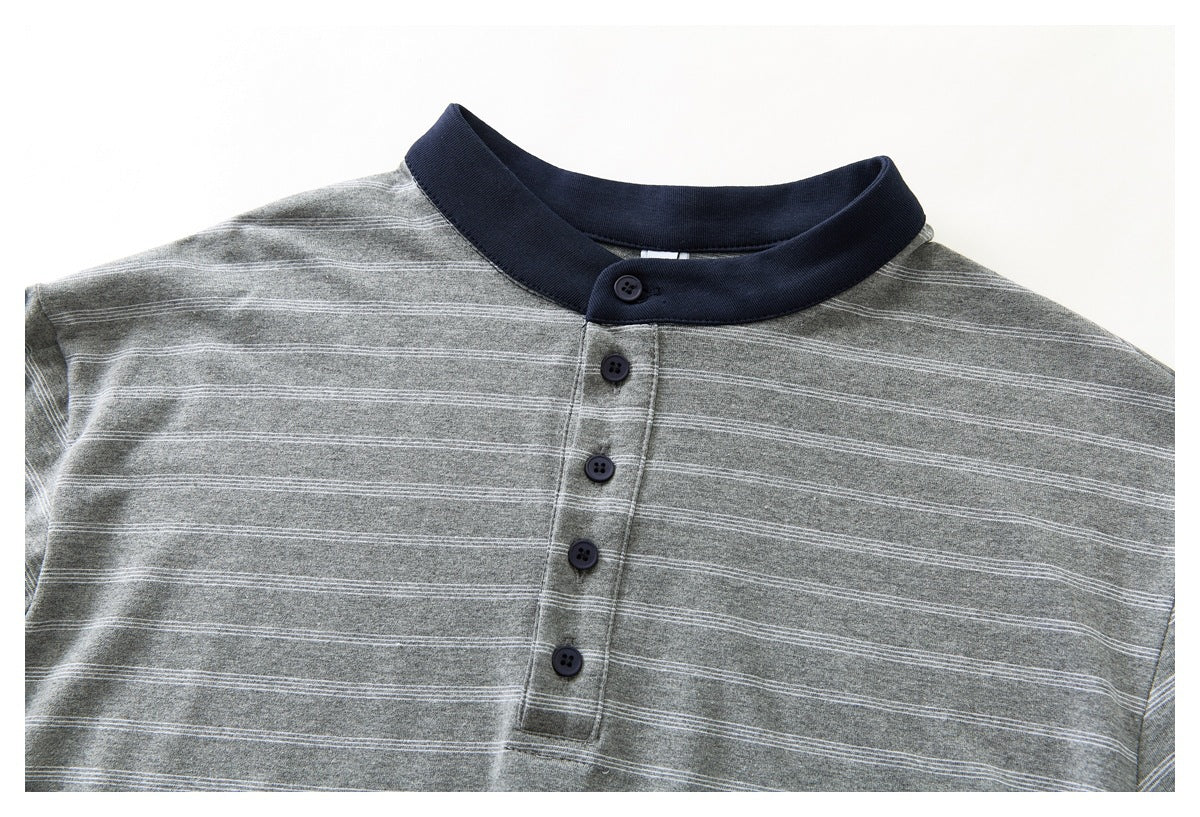 Close-up of the gray striped shirt front, showing its navy stand collar and button placket.