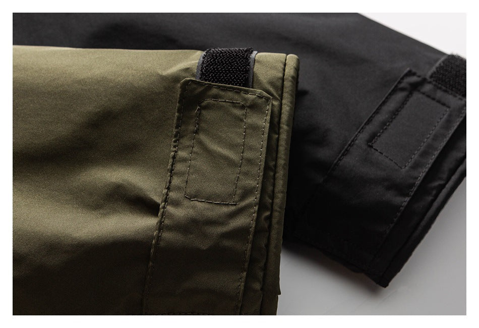 Close-up of olive and black parka sleeve cuffs with hook-and-loop adjustment tabs.