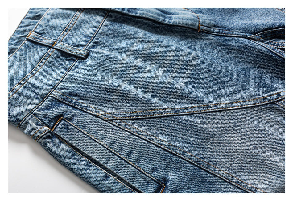 Close-up of light blue jeans with curved panel seams and a belt loop.