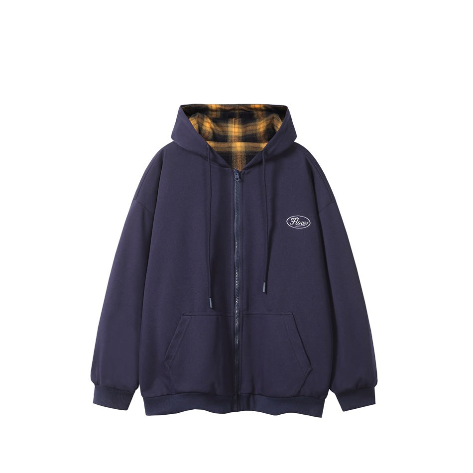Navy zip-up hooded sweatshirt flat lay with yellow and black plaid hood lining and embroidered chest patch