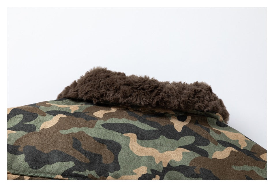 Close-up of a dark brown plush collar against green, tan, and black camouflage fabric.