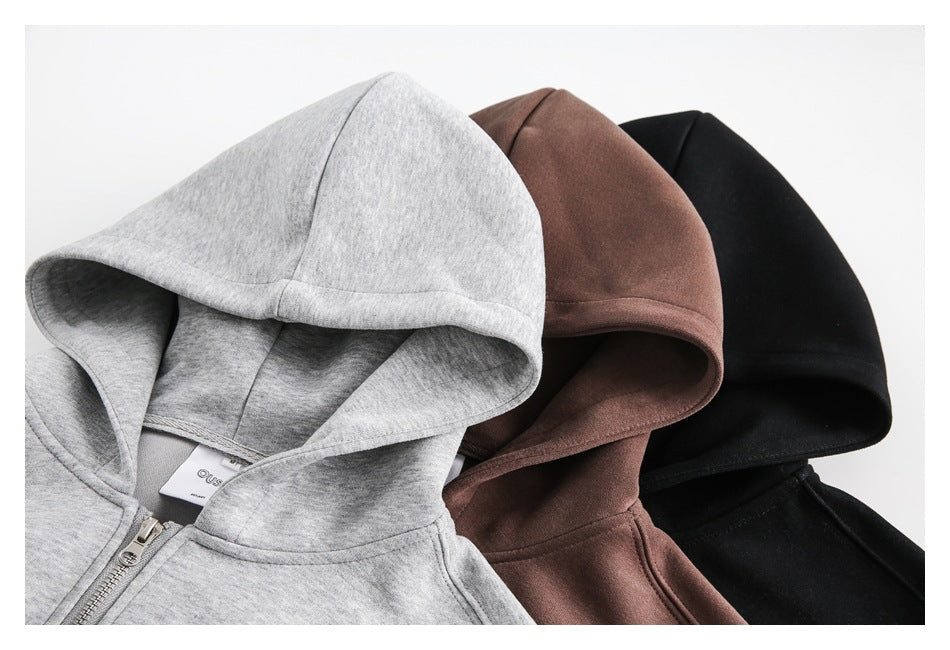 Close-up of three hoodie hoods in heather gray, dark brown, and black, arranged side by side.