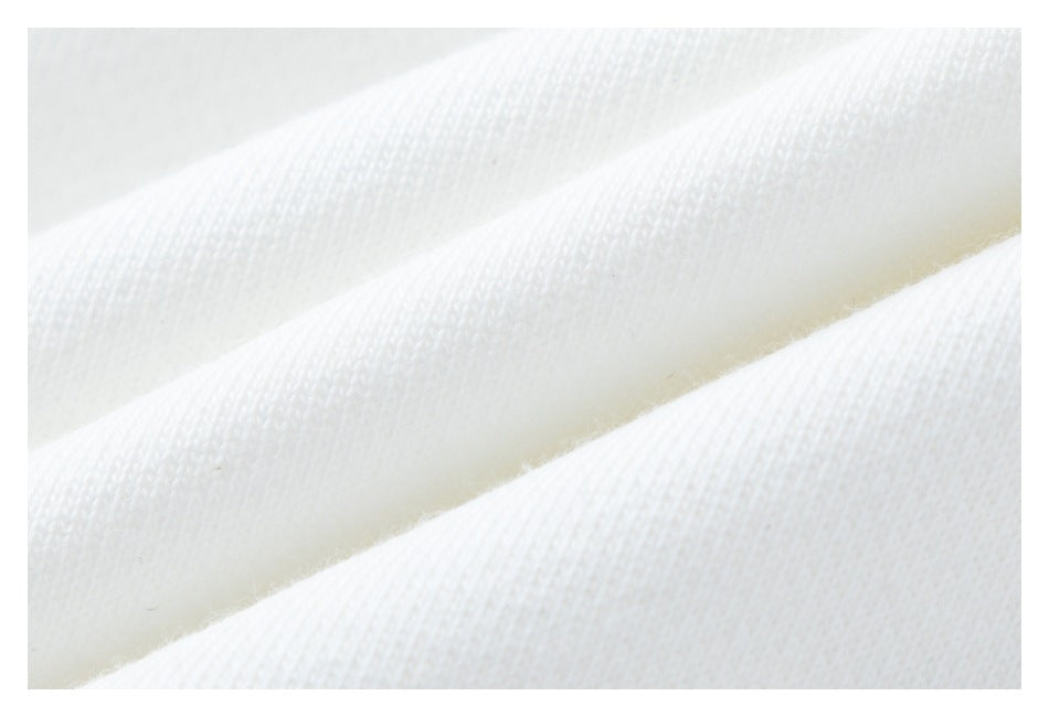 Macro view of the soft-looking knit texture of white garment fabric.
