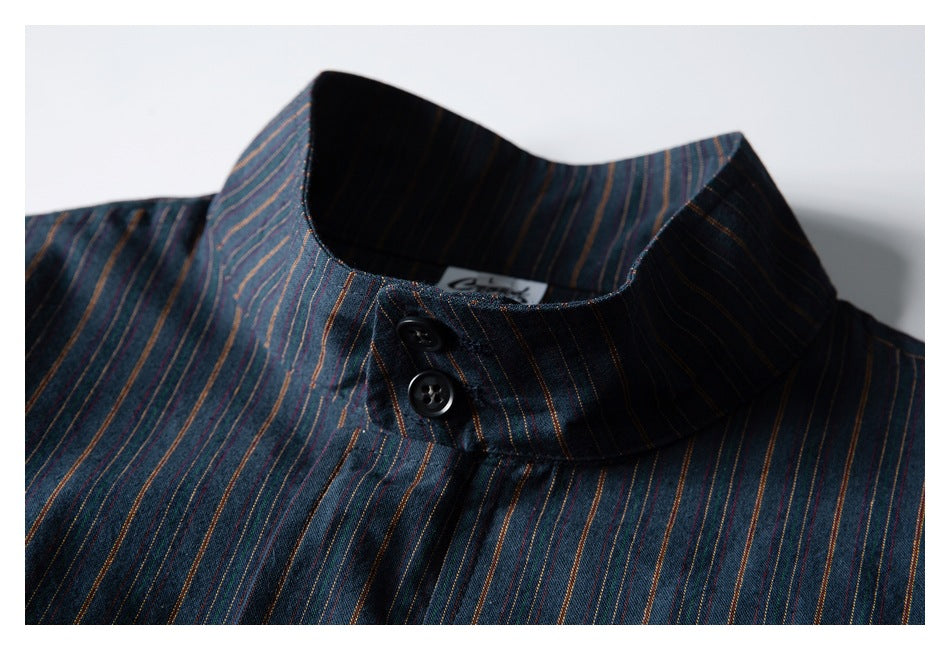 Close-up of a dark blue multicolored pinstriped jacket collar and its two black buttons.