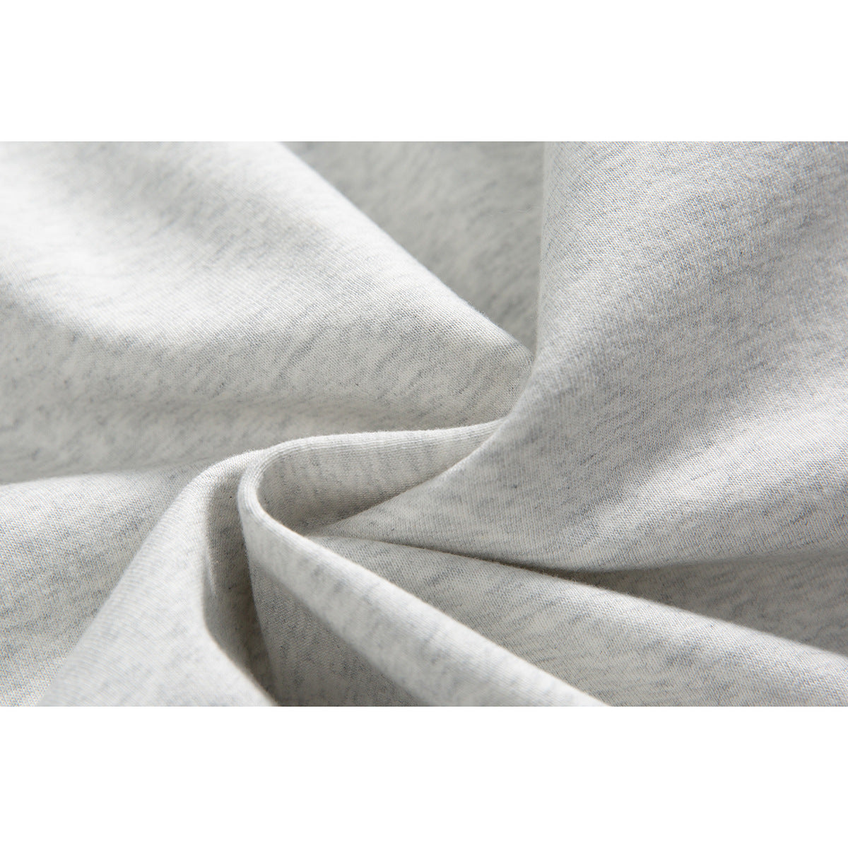 Close-up of the light gray marl hoodie fabric, showing its fine heathered texture and folded seam.