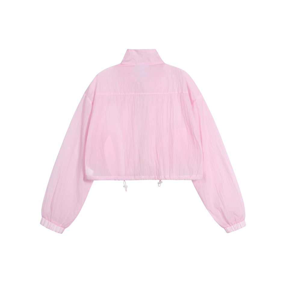 Back view of a light pink cropped jacket with a stand collar, long sleeves, elastic cuffs and adjustable hem.