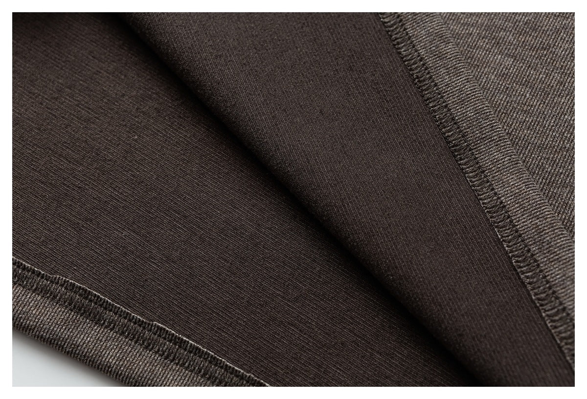 Close-up of the brown garment's interior fabric and overlocked seam stitching.