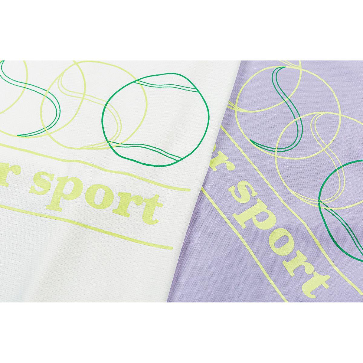 Close-up of white and lavender shirt fabric with lime lettering and green abstract loop graphics.