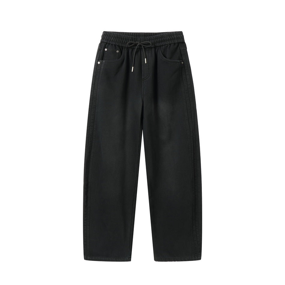 Front view of black washed casual pants with elastic drawstring waist, slant pockets and side seam detailing
