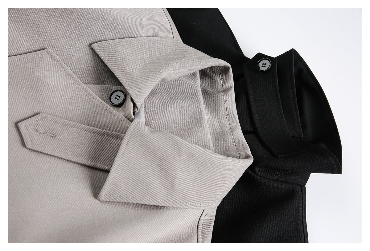 Close-up of taupe and black jackets showing collars, overlapping front panels, stitching, and buttons.