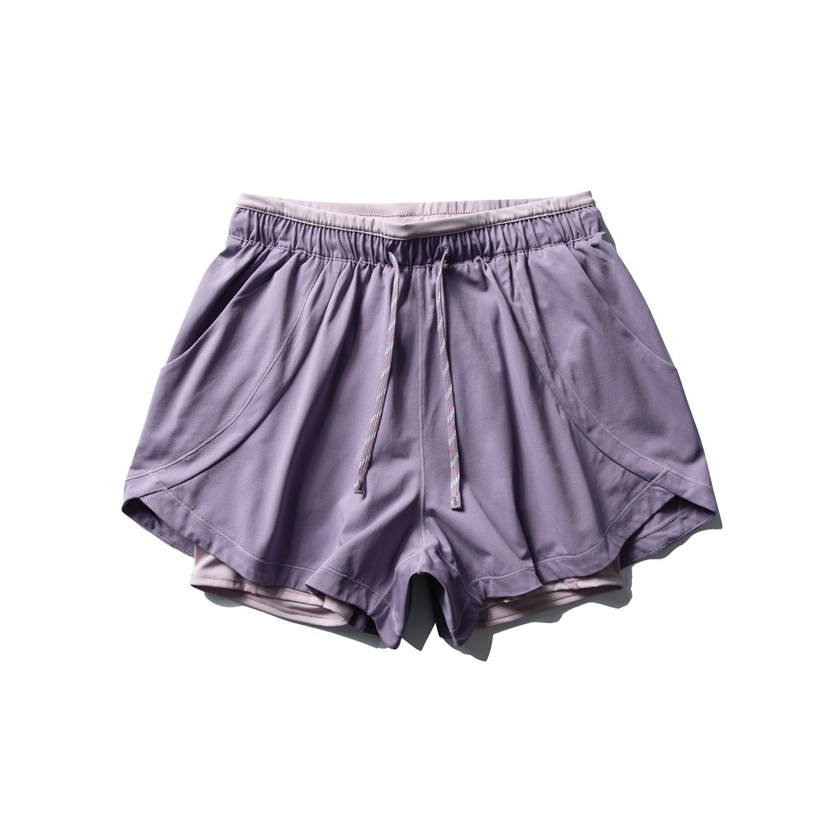 Plum purple athletic shorts with drawcord, side pockets and curved hem, laid flat, front view