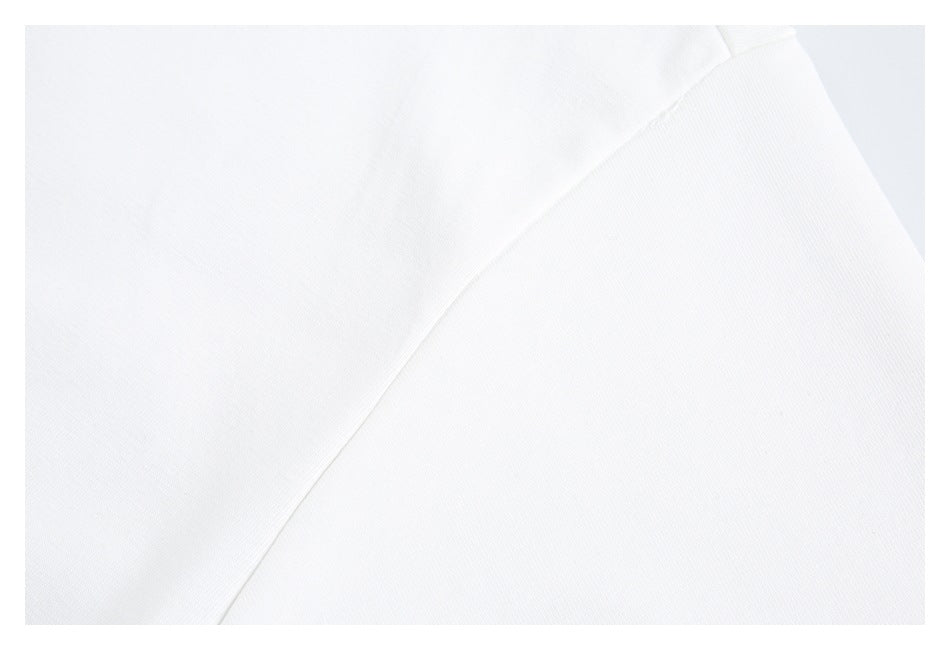 Close-up of white garment fabric and a curved seam.