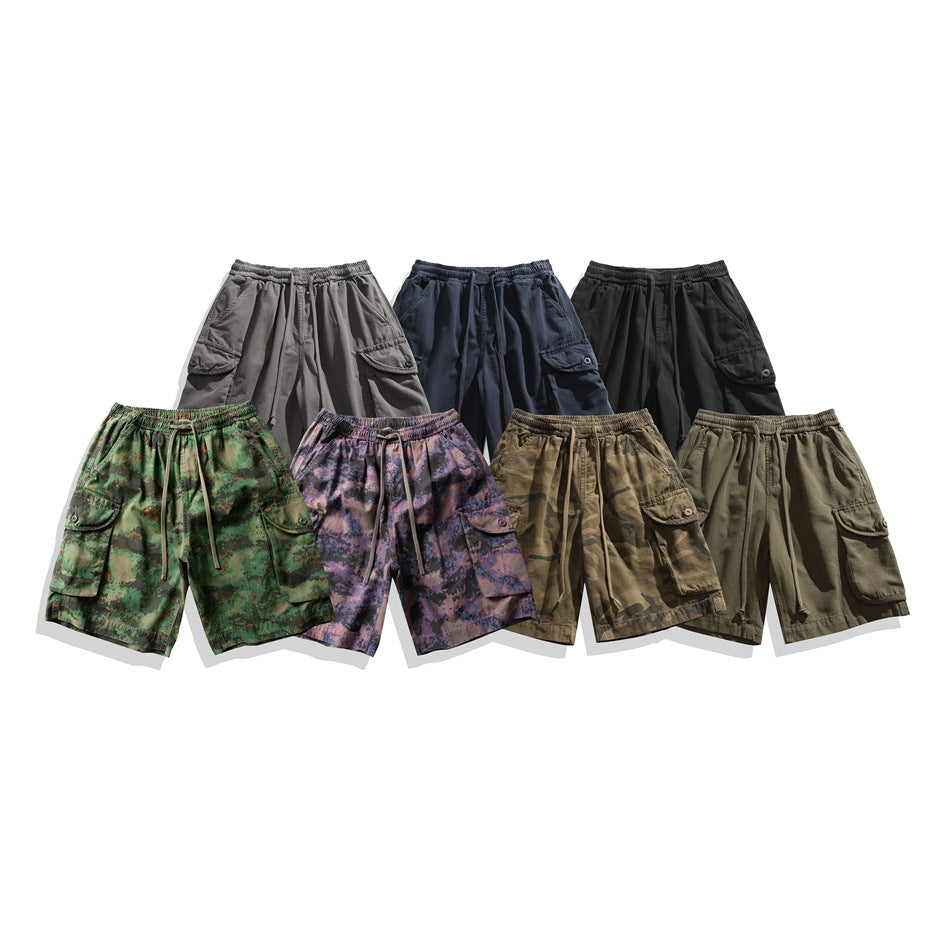 Seven pairs of elastic-waist cargo shorts arranged together in gray, navy, black, green, purple camouflage, brown camouflage