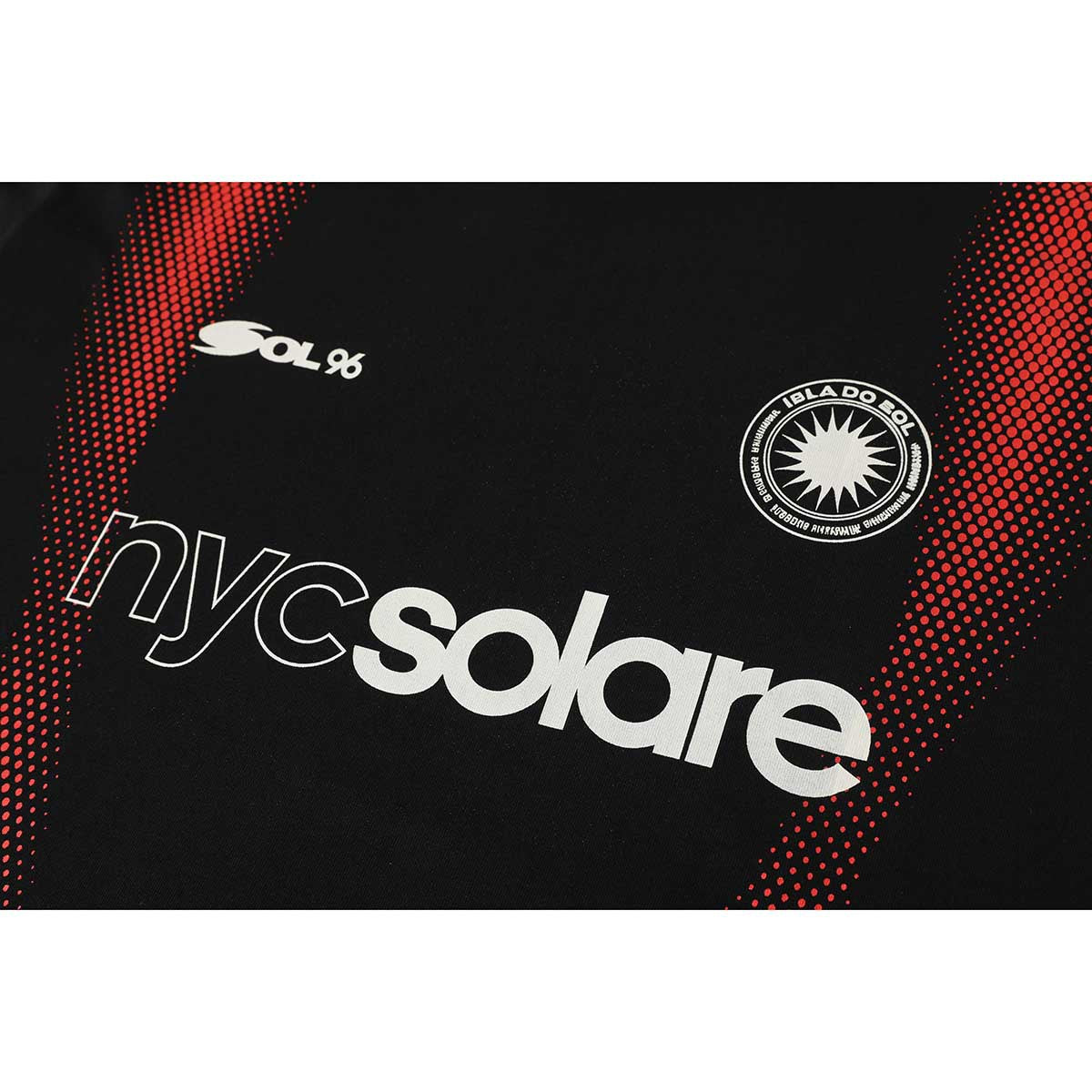 Close-up of a black T-shirt with red dotted side panels and white Sol 96, circular sun emblem, and nyc solare graphics.