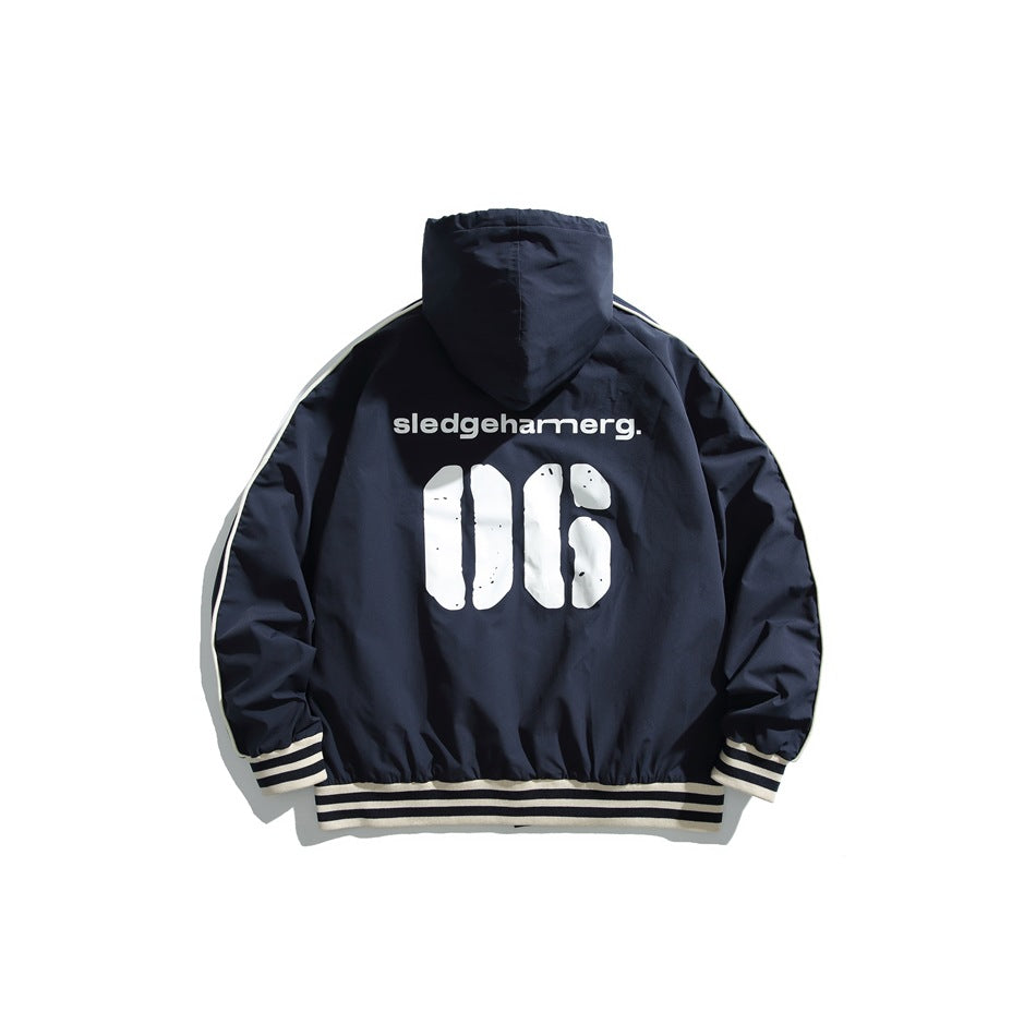 Back view of a navy hooded jacket with cream piping and striped ribbed cuffs and hem, printed with white graphics.