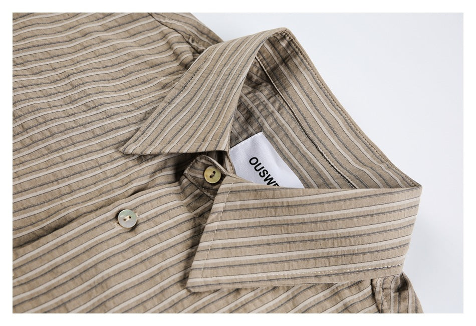 Close-up of the taupe striped shirt's collar, buttons, and sewn-in neck label.
