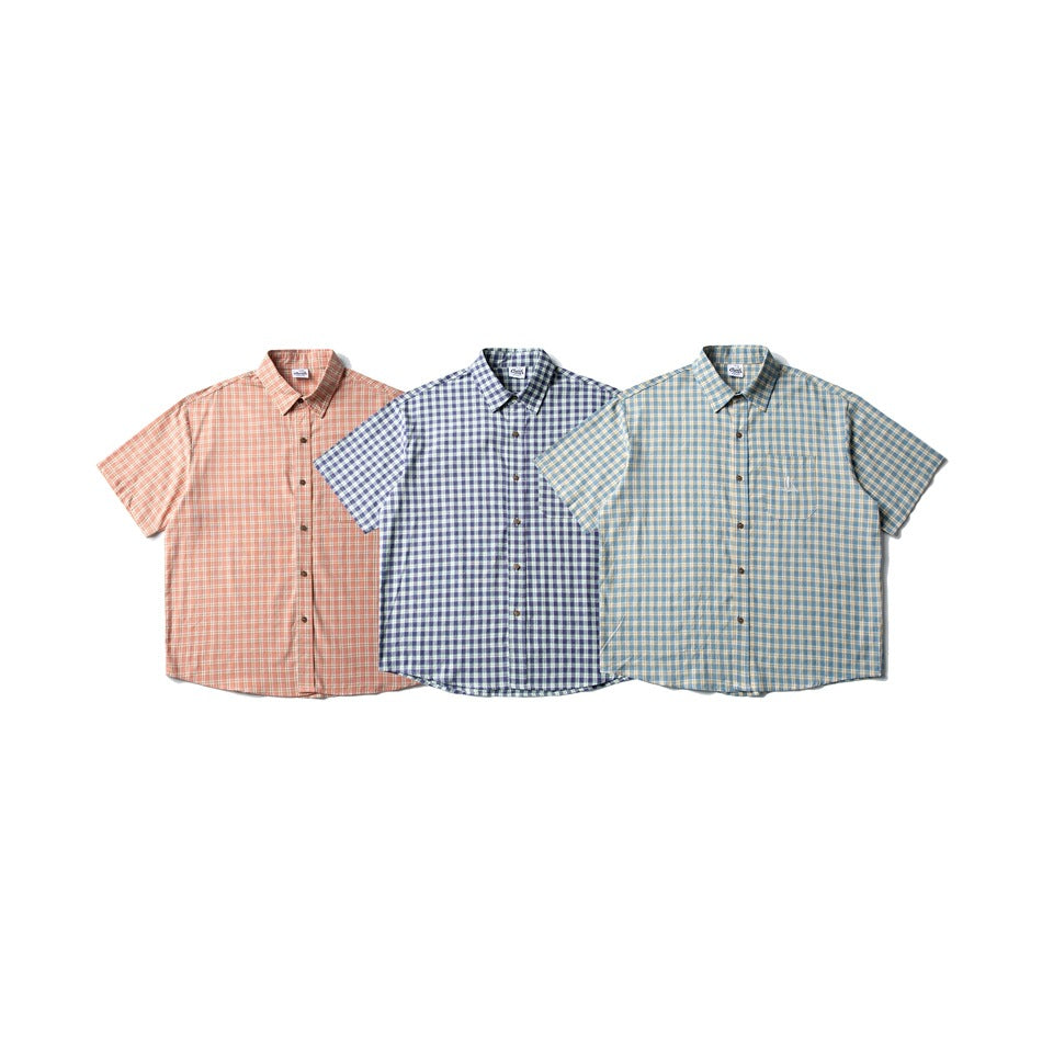 Three short-sleeve plaid button-up shirts arranged side by side in peach, navy, and blue colorways.