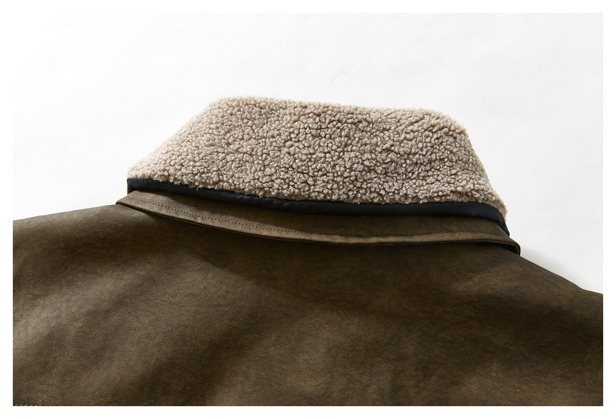 Close-up of a brown jacket collar with a thick cream looped-texture lining.