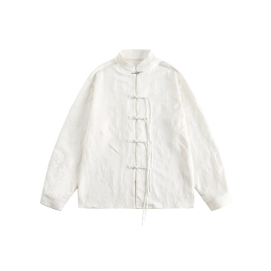 Off-white textured stand-collar shirt with knotted frog buttons and long cord ties, flat lay front view