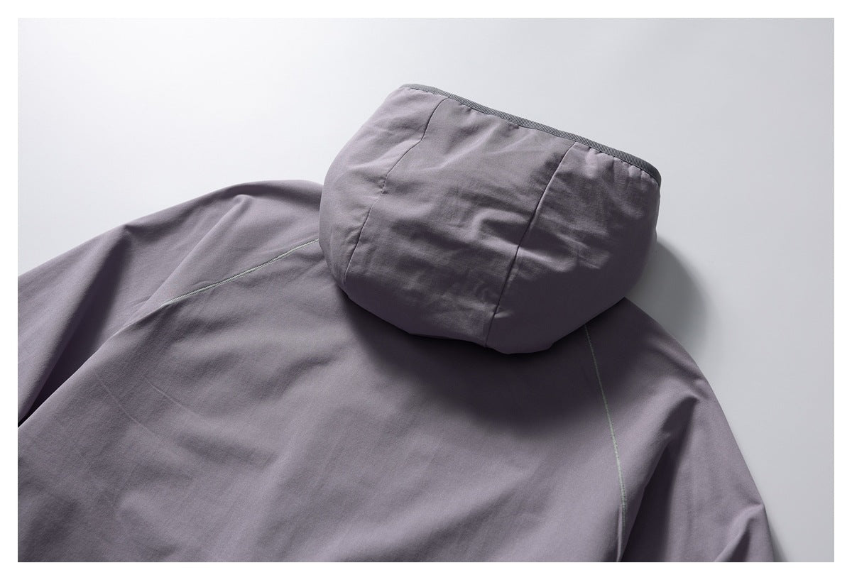 Close-up of the back of a gray jacket showing its hood and seam details.