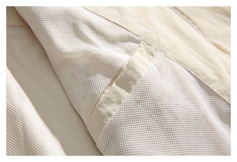 Close-up of pale mesh lining with a beige fabric seam on the jacket.