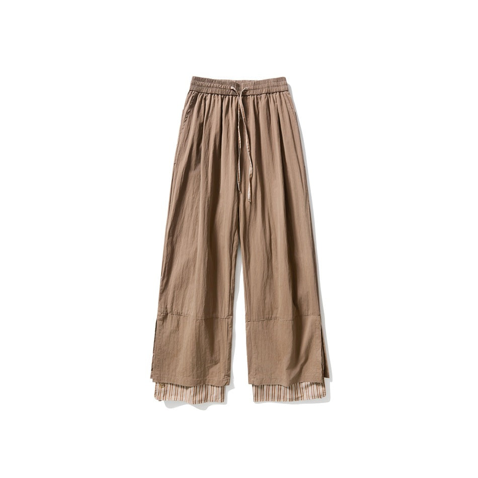 Brown wide-leg drawstring pants with a striped layered hem, flat front view