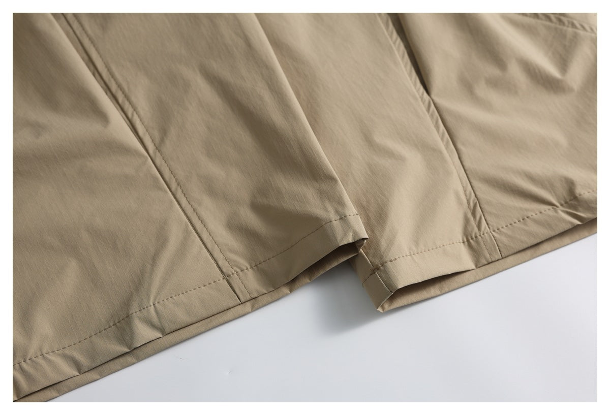 Close-up of tan garment hems and stitched seams along the lower edges.