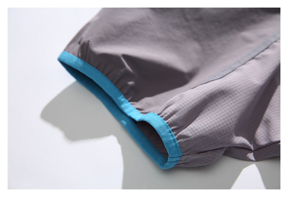 Close-up of a blue-trimmed sleeve edge and gray patterned side panel.