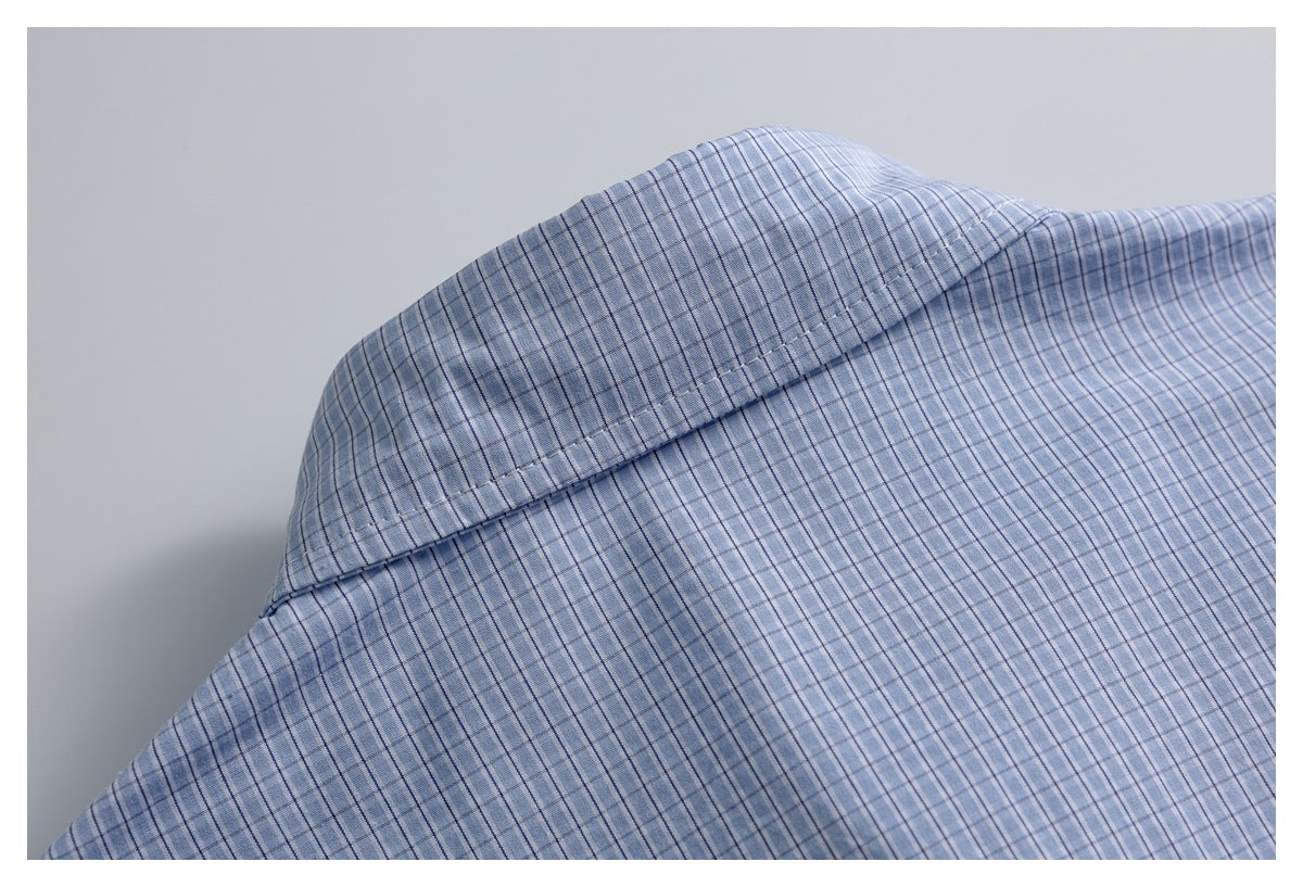 Close-up of the shoulder and collar area of a blue-and-white check shirt.
