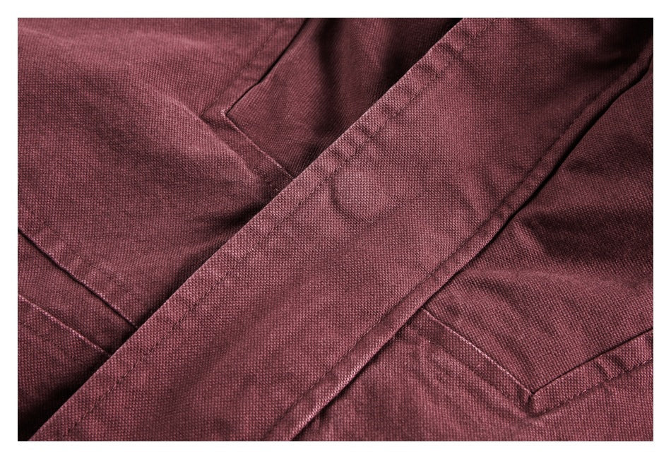 Close-up of burgundy fabric and intersecting stitched seams.